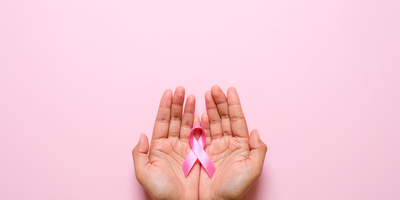 Palms of hands with a pink Breast Cancer ribbon