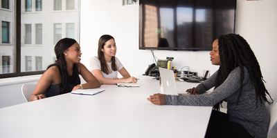 3 individuals in an interview process in an office