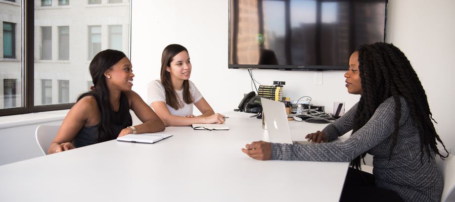 3 individuals in an interview process in an office